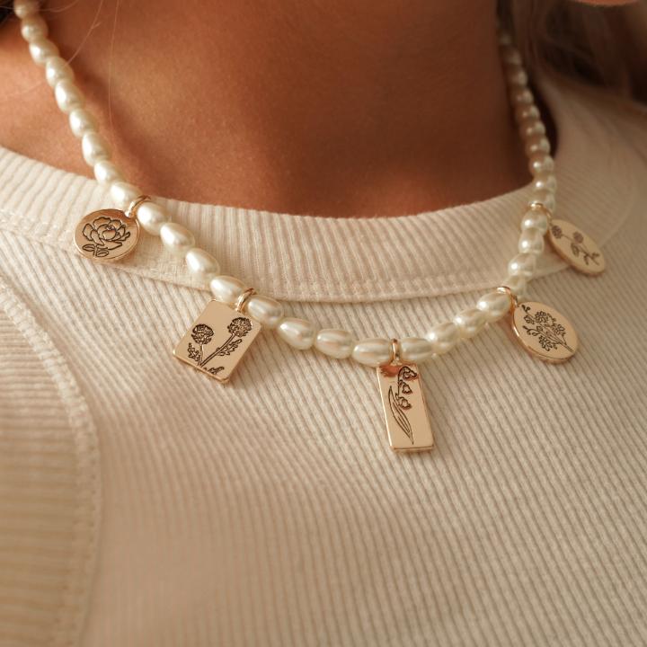 Laura Ashley Pearl Choker close up on a model wearing a white top.
