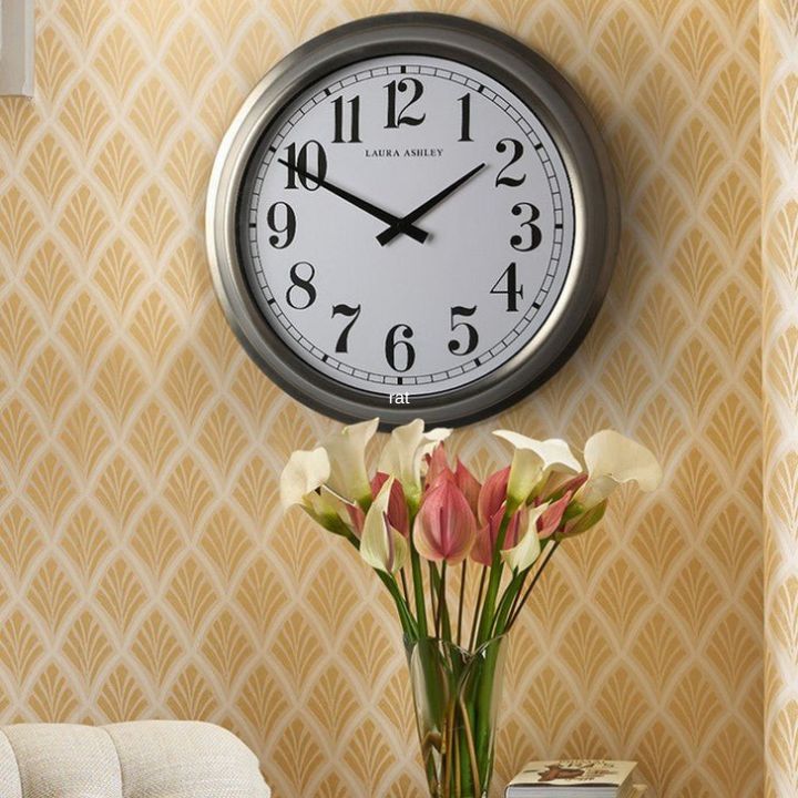 Brushed Gold clock on a wall.