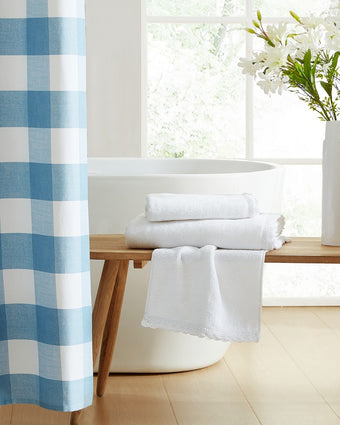 Juliette Lace Hem White 3 Piece Towel Set View of folded towels on bench