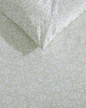 Heirloom Ditzy Cotton Green Comforter Set on a bed in a room closeup of print