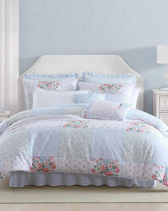 Hope Patchwork Pink Comforter Bonus Set on a bed in a bedroom setting