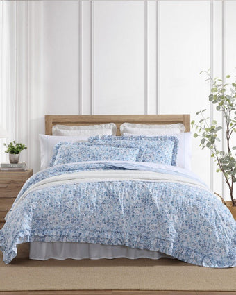 Quartet Cotton Reversible Quilt Set on a bed