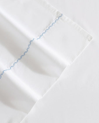 Scallop Embroidered Cotton Blue Sheet Set Close up view of embroidered detail
