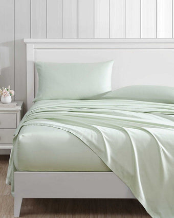 Solid T800 Cotton Rich Green Sheet Set on a bed in a room setting
