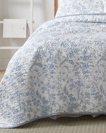 Amberley Bright Blue Reversible Quilt Bonus Set close up view of quilt with coordinating print hem
