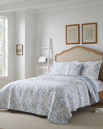 Amberley Bright Blue Reversible Quilt Bonus Set angle view of quilt, 2 shams and 1 pillow cover