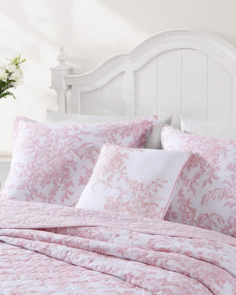 Bedford Pink 20X20 Decorative Pillow - Close up view of shams, pillows and quilt on a bed