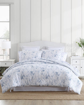 Belinda Blue Comforter Set View of comforter and shams on a bed.