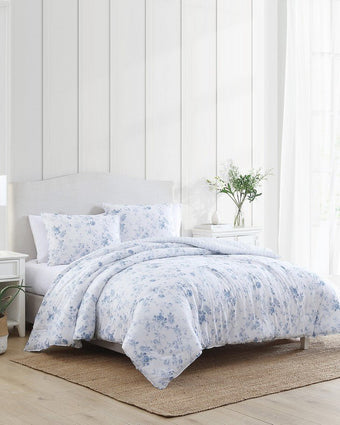 Belinda Blue Comforter Set Side view of comforter and shams on a bed