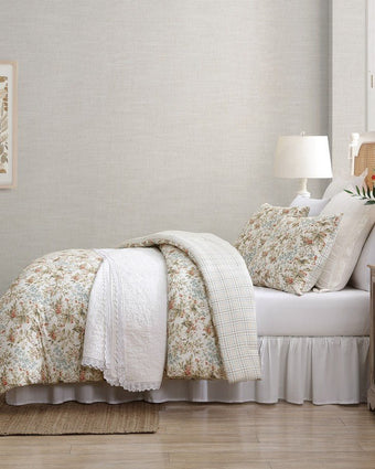 Bramble Floral Beige Cotton Reversible Comforter Set side view of comforter and shams on a bed