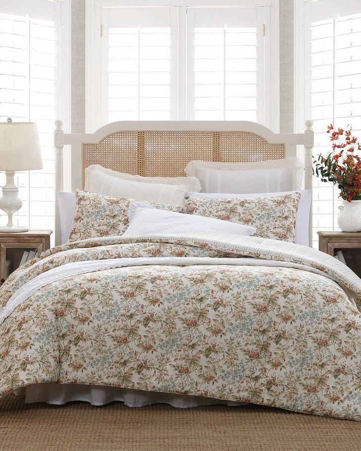 Bramble Floral Beige Cotton Reversible Comforter Set view of comforter and shams on a bed
