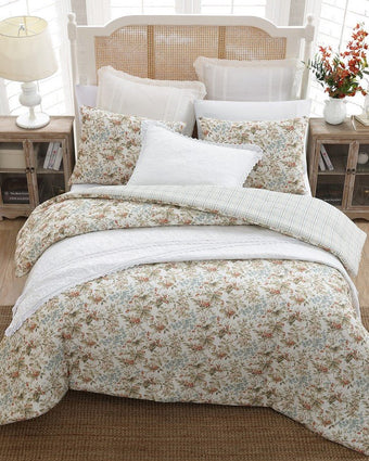 Bramble Floral Beige Cotton Reversible Comforter Set aerial view of comforter and shams on a bed