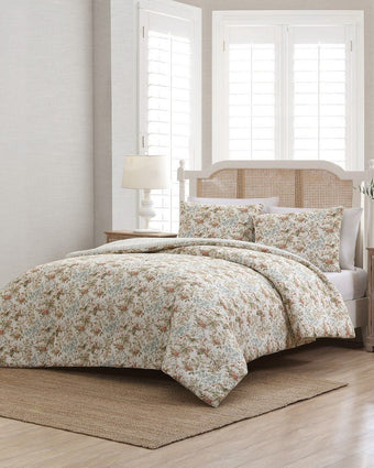 Bramble Floral Beige Cotton Reversible Comforter Set angle view of comforter and shams on a bed