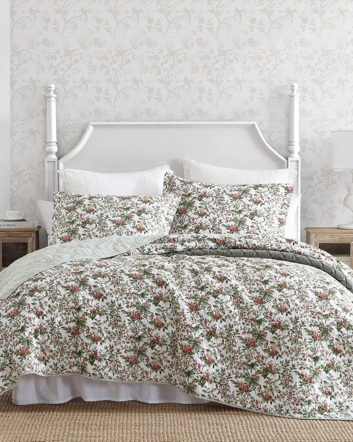 Bramble Floral Green Cotton Reversible Quilt Set view of quilt and shams on a bed