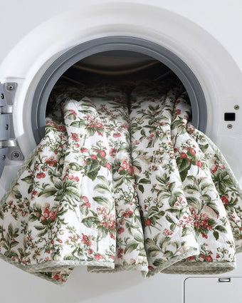 Bramble Floral Green Cotton Reversible Quilt Set view of quilt in a dryer