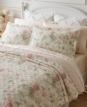 Breezy Floral Pink Quilt Set - View of quilt and shams on a bed