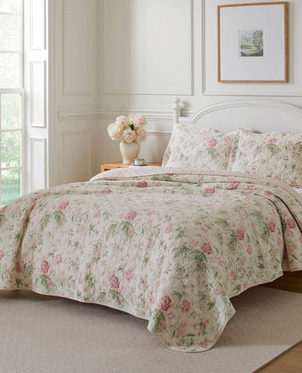 Breezy Floral Pink Quilt Set - View of quilt and shams on a bed