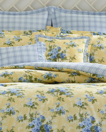 Cassidy Yellow Duvet Cover Bonus Set -Close-up view of duvet cover, standard shams, euro shams, and decorative pillows on bed
