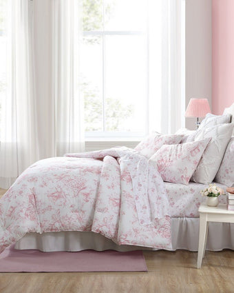 Delphine Pink Comforter Set Side view of comforter and shams on a bed