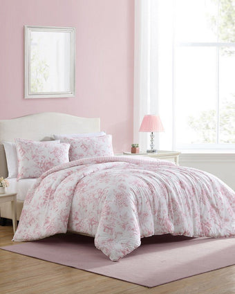 Delphine Pink Comforter Set View of comforter and shams on a bed