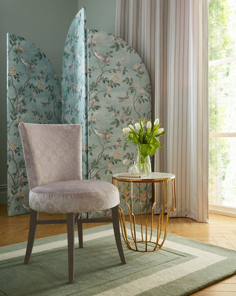 Eglantine Smoke Green Fabric on partition screen behind a chair.