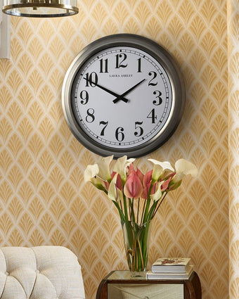 Gibson Large Brushed Stainless Clock - View of clock on a wall