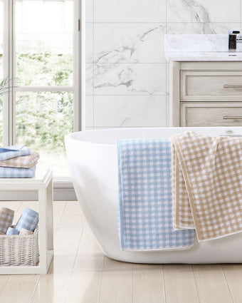 Ginny Beige Cotton Terry 3 Piece Towel Set - View of  blue/white towel and tan/white towel on a bath tub