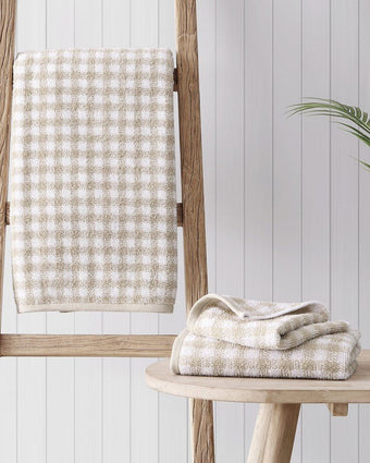 Ginny Beige Cotton Terry 3 Piece Towel Set - View of  towel hanging and a rack and folded hand towel and wash cloth