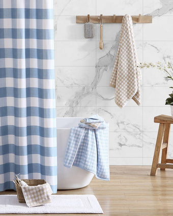 Ginny Beige Cotton Terry 3 Piece Towel Set - View of blue/white and tan/white towels hanging and on a tub