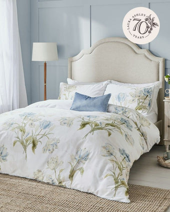 Gosford Seaspray Duvet Cover Set on a bed in bedroom with a large blue wall