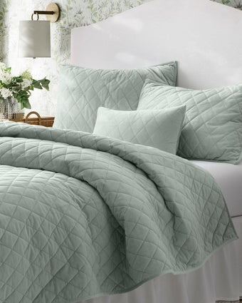  Green Velvet Diamond Stitch Quilt Bonus Set: Close up view of quilt, shams and decorative pillow cover on a bed