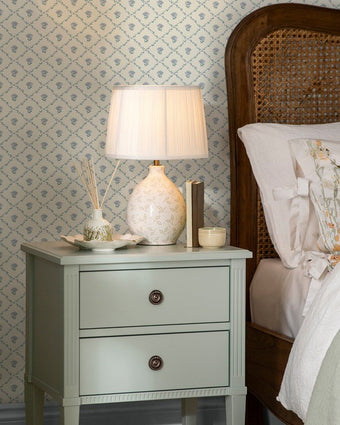 Kate Pale Seaspray Blue Wallpaper on a wall behind a land and side table