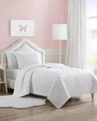 Kids Butterfly Kiss White Microfiber Reversible Quilt Set - View of quilt and sham on a bed