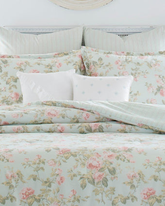Madelynn Duvet Cover Bonus Set - Closeup view of duvet cover, standard shams, euro shams, and decorative pillows on a bed