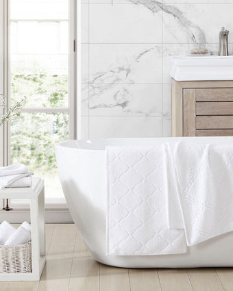 Maude Solid Jacquard White Quick Dry Cotton Terry 6 Piece Towel Set - View of towel folded on bath tub
