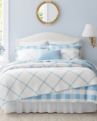 Melody Patchwork Blue Quilt - View of quilt and shams on a bed
