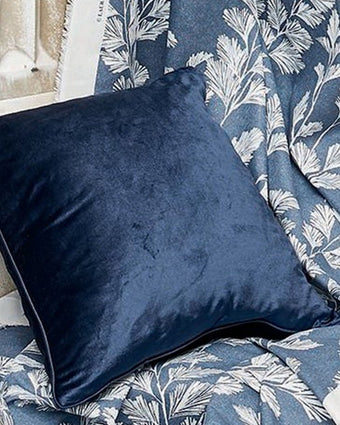 Nigella Midnight Velvet Cushion - View of cushion laying on fabric