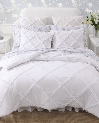 Norah White Microfiber Comforter Set  View of comforter and shams on a bed