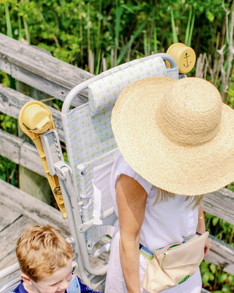 Palmetto Dune High Backpack Beach Chair on a model as she walks to the beach