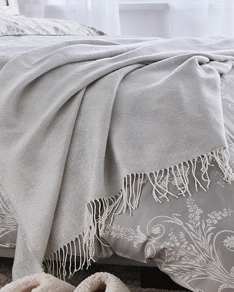 Payton Silver Throw Draped Over Duvet