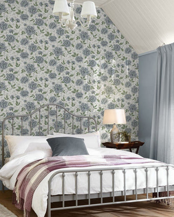 Pickworth Posy Pale Seaspray Blue Wallpaper on a wall behind a bed with white bedding