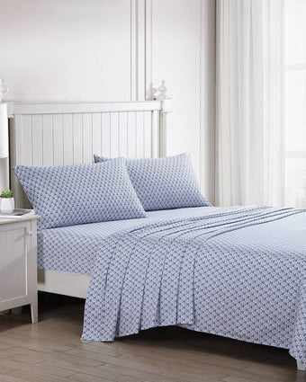 Rosemarie Blue Cotton Sateen Sheet Set - View of sheets and pillowcases on bed