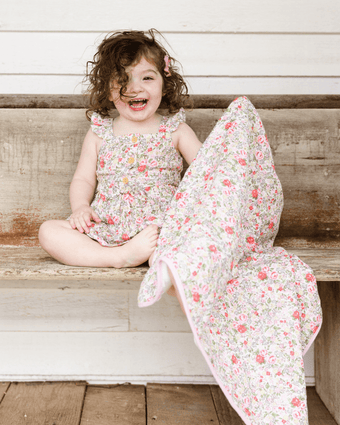 Rowena Crinkle Gauze Receiving Blanket and Gift Bag  View of model holding blanket.