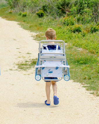 Sea Turtle Child Beach Chair strapped to child back as he walks to the beach
