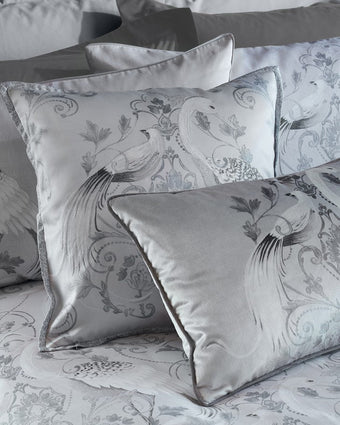 Tregaron Embroidered Silver Cushion - Close up view of cushion on a bed
