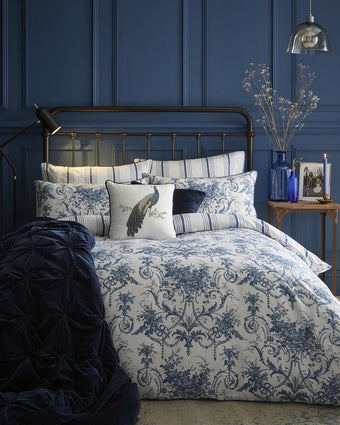 Tuileries Midnight Duvet Cover Set on a bed in a blue bedroom