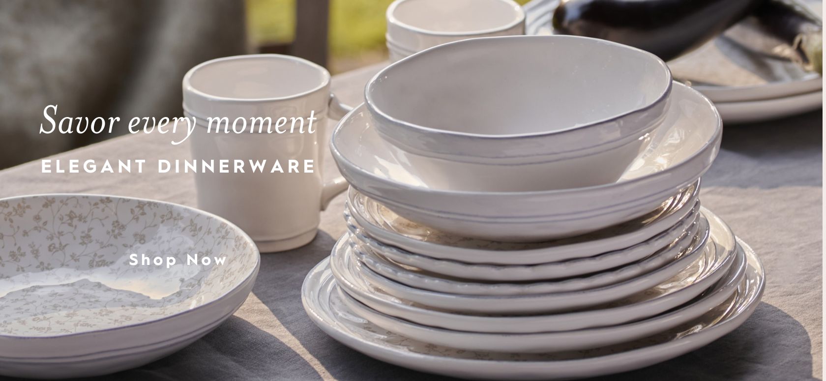 Artisans dinnerware stacked on a table in outdoor setting.